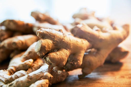 piles of ginger on wooden chopping board