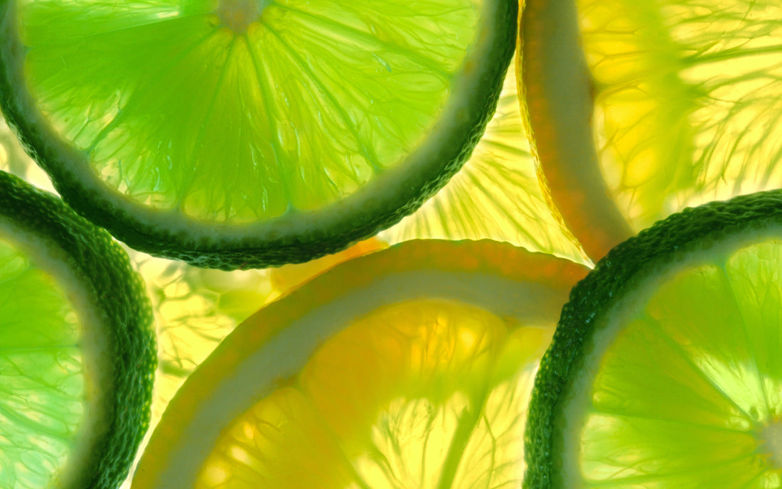 close up of lemons and limes with light shining through