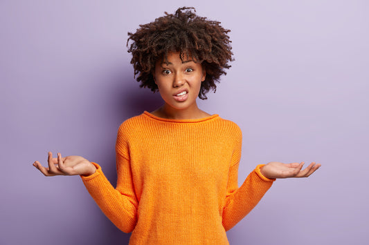 woman in orange shirt on purple background